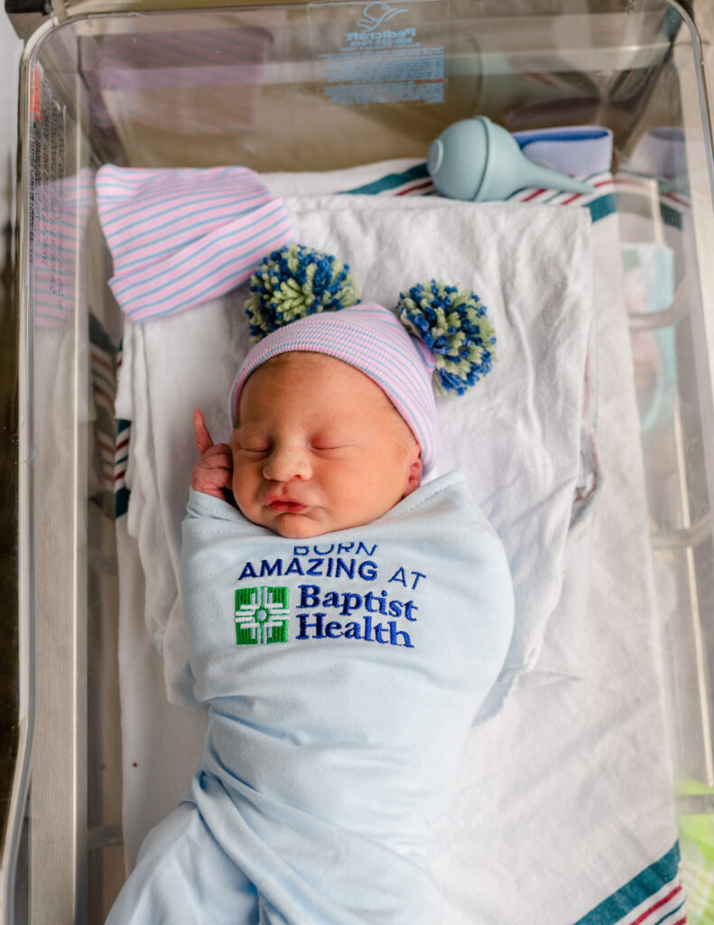 fresh 48 newborn with hospital hat in bassinet
