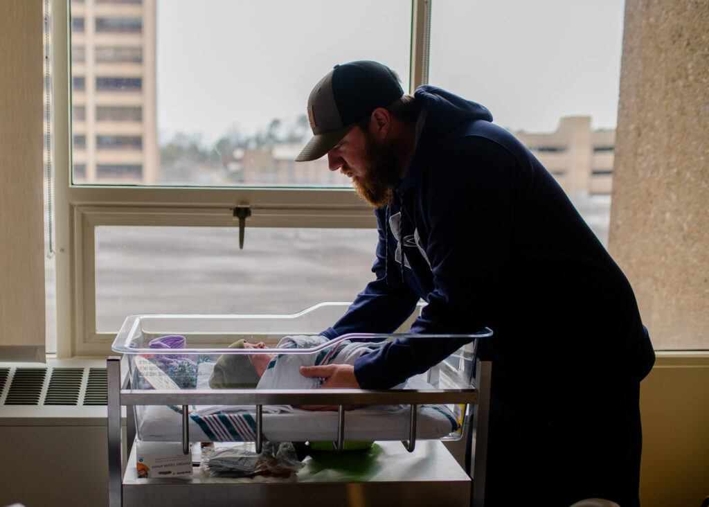 Dad and newborn son bonding in hospital 