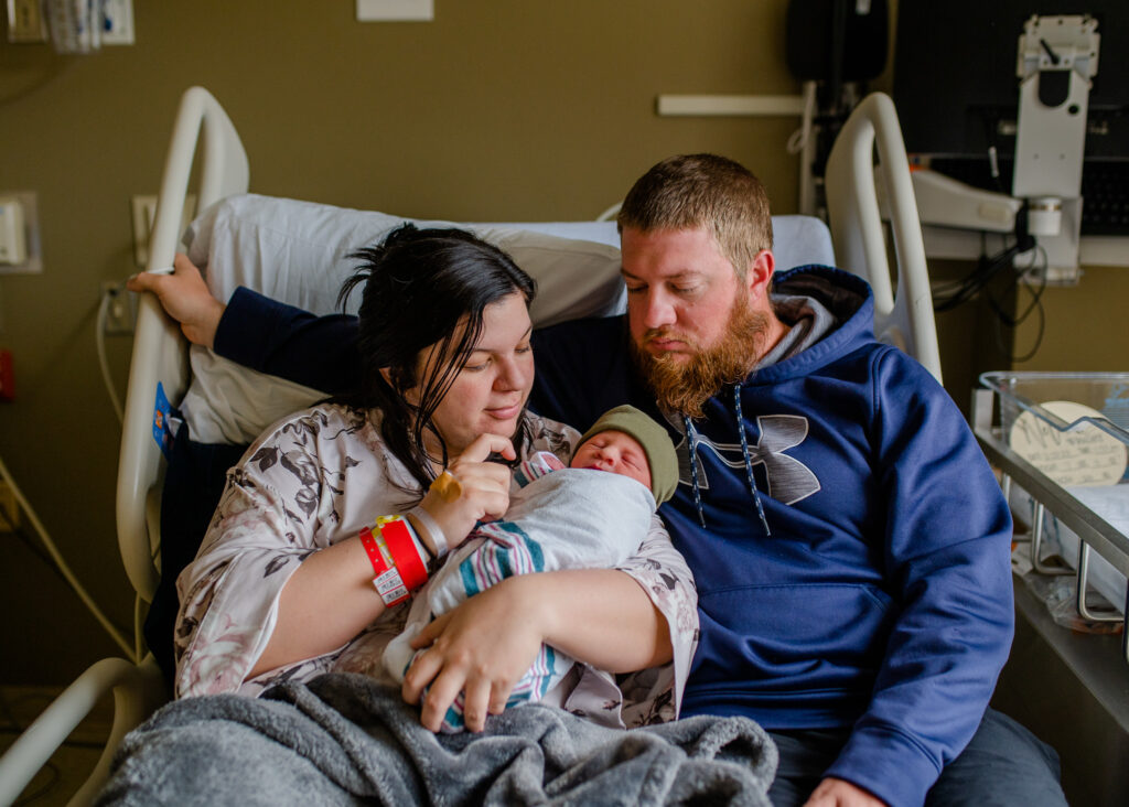 A new family member is cuddled during fresh 48 session in the hospital