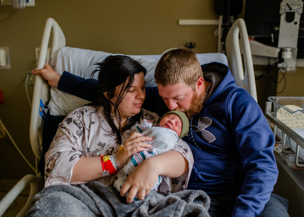 Mom, Dad, and baby cuddle in the hospital bed during fresh 48  in Little Rock