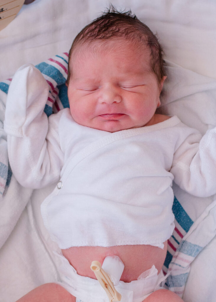 freshly born baby in the hospital bassinet